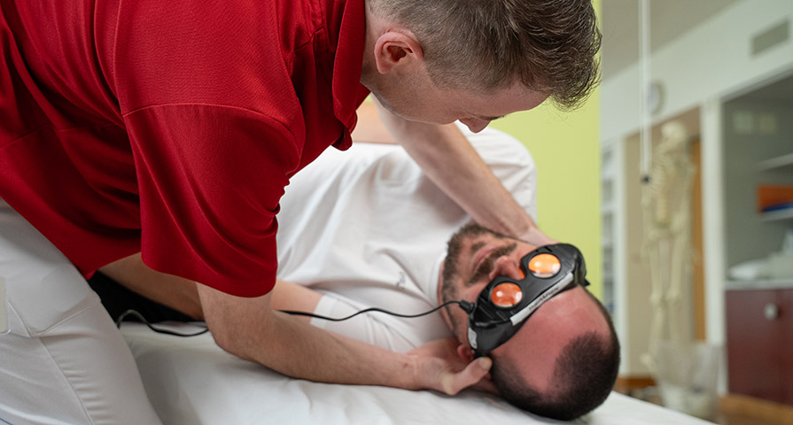 Physiotherapie, Schwindel, Videobrillen, Videonystagmusbrillen Bild eines Physiotherapeuten und eines Patienten, bei welchem eine spezielle Videobrillen (Videonystagmusbrillen) zum Einsatz kommt.